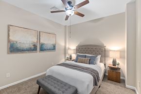 Cincinnati apartment for rent - A bedroom with a large bed and a ceiling fan.