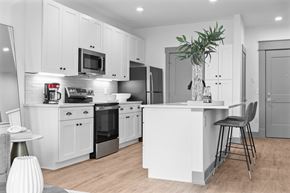 Cincinnati apartment for rent - A modern kitchen with white cabinets and stainless steel appliances. at The Ridge Apartments, Cincinnati, OH