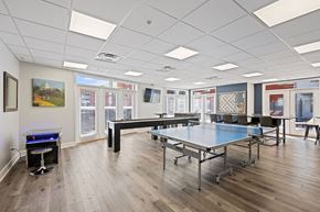 Cincinnati apartment for rent - a game room with ping pong tables and a foosball
