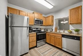 Cincinnati apartment for rent - A kitchen with wooden cabinets and stainless steel appliances.