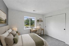 Lima apartment for rent - A bedroom with a large bed and a desk with a chair.