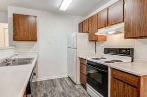 Lima apartment for rent - a kitchen with white appliances and wooden cabinets