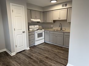 Oregon townhouse for rent - A kitchen with a white stove and cabinets.
