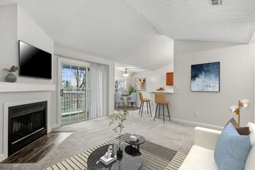 Ft Wright apartment for rent - A living room with a fireplace and a television on the wall.