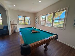 Dayton townhouse for rent - A pool table in a room with a view of the backyard.