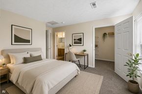 Columbus apartment for rent - A bedroom with a large bed and a desk with a chair.