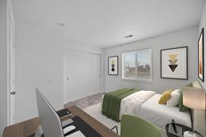 Findlay apartment for rent - A bedroom with a bed, desk, and chair at Crystal Glen Apartments, Findlay, OH