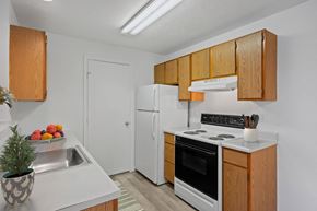 Findlay apartment for rent - A kitchen with wooden cabinets and a white refrigerator at Crystal Glen Apartments, Findlay