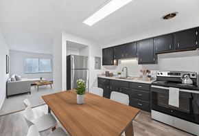Dayton apartment for rent - a kitchen and dining room with black cabinets and a wooden table