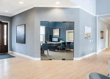 Living room with a large mirror and a dining room