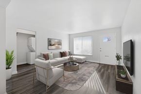 Cincinnati apartment for rent - A living room with a white couch, a coffee table, and a television.
