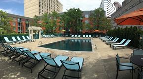 Cincinnati apartment for rent - a large pool with chairs and umbrellas at a hotel