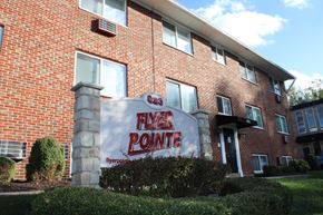 Dayton apartment for rent - A brick building with a sign that says Flyer Pointe.