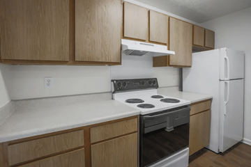 Indianapolis apartment for rent - A kitchen with wooden cabinets and a white refrigerator.