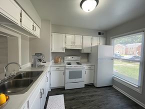 Oregon townhouse for rent - a kitchen with white appliances and white cabinets