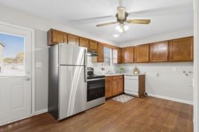 Louisville apartment for rent - A kitchen with wooden cabinets and a stainless steel refrigerator.