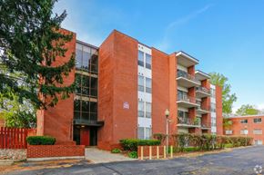 Dayton apartment for rent - A red brick building with a black door and windows.