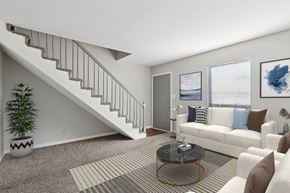 Louisville apartment for rent - A living room with a staircase and a couch.