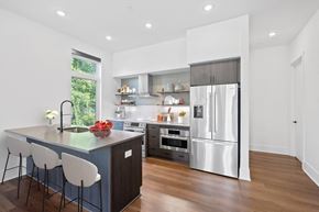 Cincinnati apartment for rent - a kitchen with a large island and a stainless steel refrigerator at Four23/Hoge, Ohio