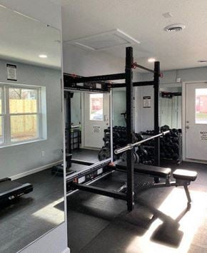 Bowling Green apartment for rent - A gym with a squat rack and a bench.