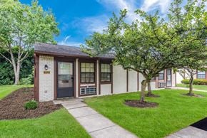 Columbus apartment for rent - a small building with a sidewalk and trees in front of it at Parkside at Maple Canyon Apartments, Columbus, OH 43229