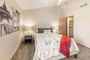 Columbus apartment for rent - a bedroom with a bed and a closet at Parkside at Maple Canyon Apartments, Ohio, 43229