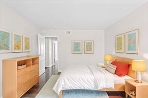Indianapolis apartment for rent - A bedroom with a bed, nightstand, and a dresser with drawers at Fountain Parc Apartments, Indianapolis, IN 46220