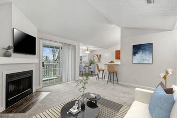 Ft Wright apartment for rent - A living room with a fireplace and a television on the wall.