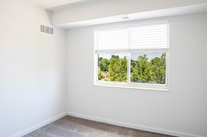 Dayton apartment for rent - an empty room with a large window and a carpeted floor
