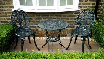A table and two chairs on a patio