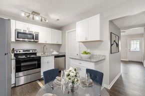 Columbus apartment for rent - A modern kitchen with a dining table set for two.