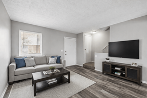 Columbus townhouse for rent - A living room with a grey couch, a coffee table, and a television. at Sharon Green Townhomes, Columbus, 43229