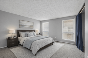 Columbus townhouse for rent - A bedroom with a large bed and a painting on the wall.  at Sharon Green Townhomes, Columbus, Ohio