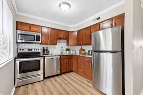 Cincinnati apartment for rent - A kitchen with wooden cabinets and stainless steel appliances.