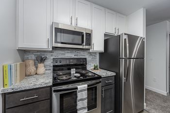 Modern kitchen with stainless steel appliances and double door refrigerators