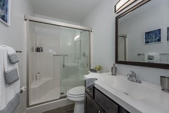 Walk-in showers with built-in bench and glass enclosure