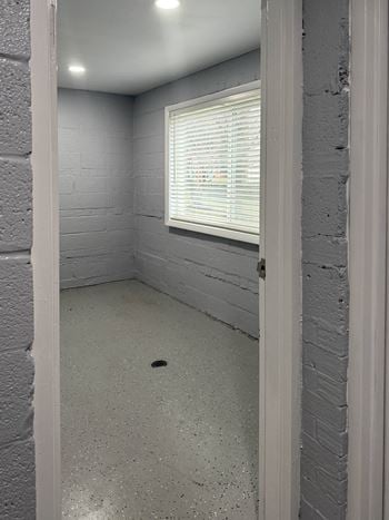 A room with a window and a door.