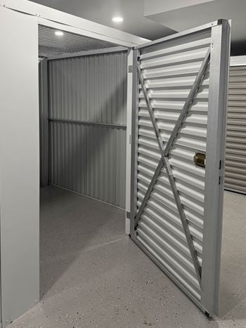 A metal gate with a lock is closed.