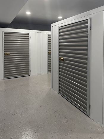 A storage facility with closed doors and a concrete floor.
