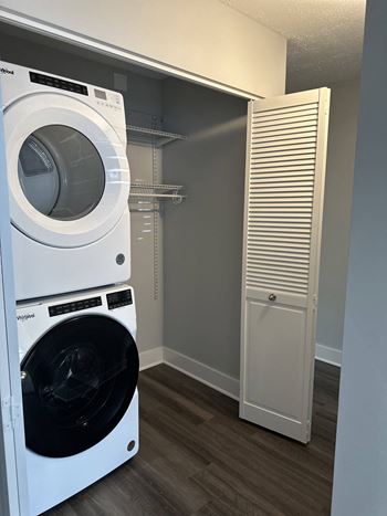 A washer and dryer in a laundry room with a closet