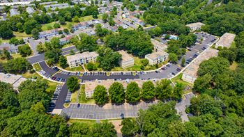 An aerial view of a parking lot with trees and buildings