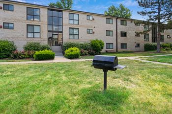 An apartment building with a mailbox in front of it