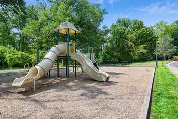 A playground with a slide in a park
