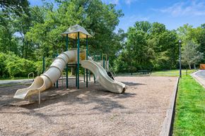 Herndon apartment for rent - a playground with a slide in a park at Stuart Woods* Apartments, Herndon, Virginia