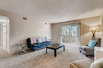 Denver apartment for rent - A living room with a blue couch and a coffee table.