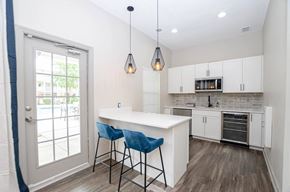 Villa Rica apartment for rent - A kitchen with a white counter and blue chairs.