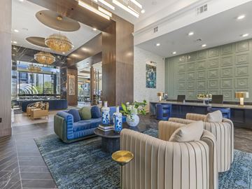 Las Vegas apartment for rent - A modern living room with a blue sofa and striped armchairs.