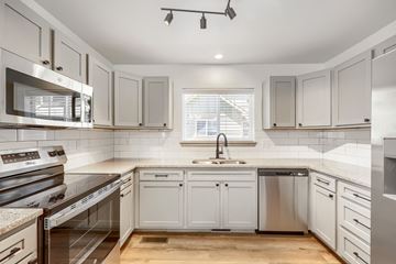 Castle Rock apartment for rent - A modern kitchen with white cabinets and stainless steel appliances.