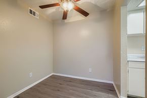 Carrollton apartment for rent - A room with a ceiling fan and light fixture.