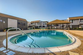 Carrollton apartment for rent - A small pool with a metal ladder sits in the middle of a courtyard.